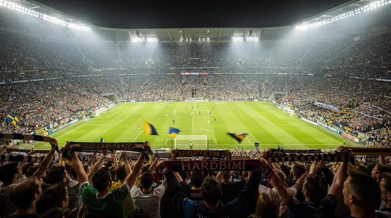Packed stadium during a night game under floodlights