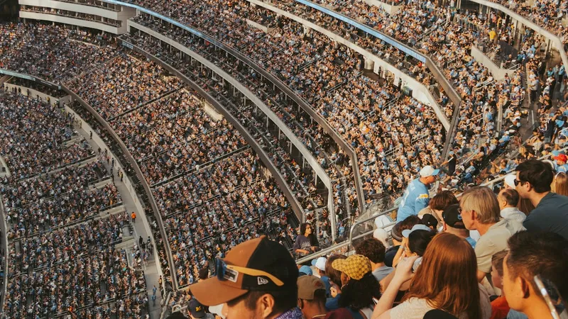 Massive stadium crowd filling every tier during a football match