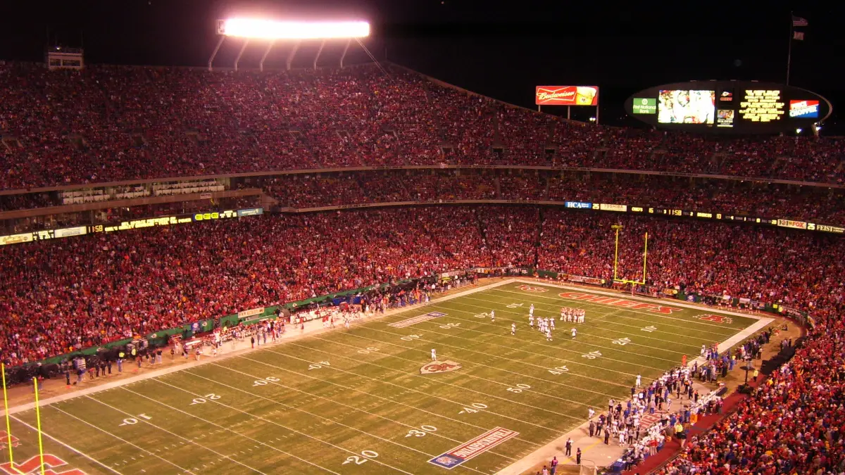 Arrowhead Stadium packed with red-clad Kansas City Chiefs fans under the lights at night