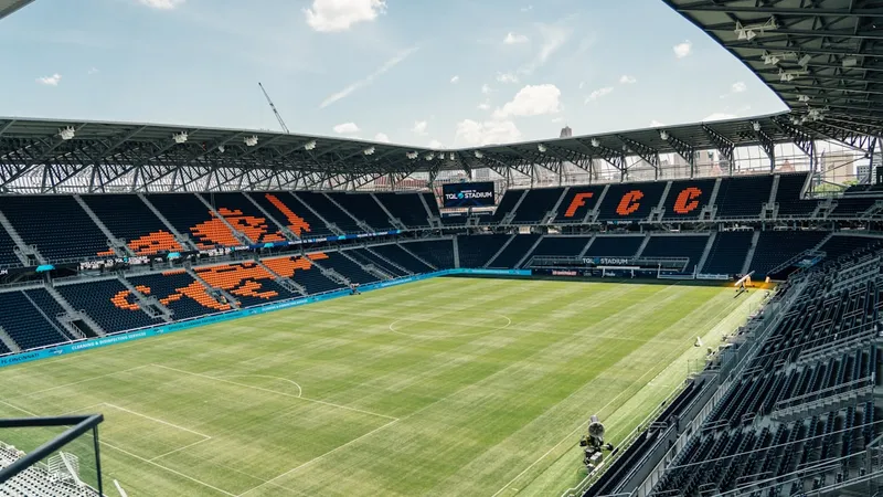 Empty soccer stadium with pristine green pitch ready for World Cup preparations