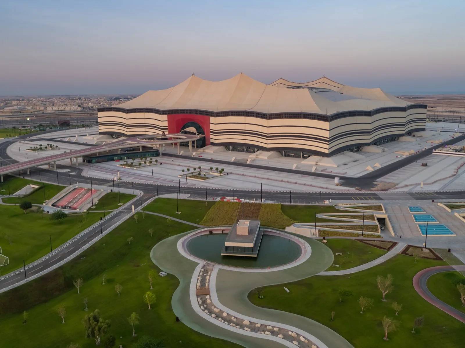 Al Bayt Stadium's giant black-and-white tent facade rising from the desert at Al Khor